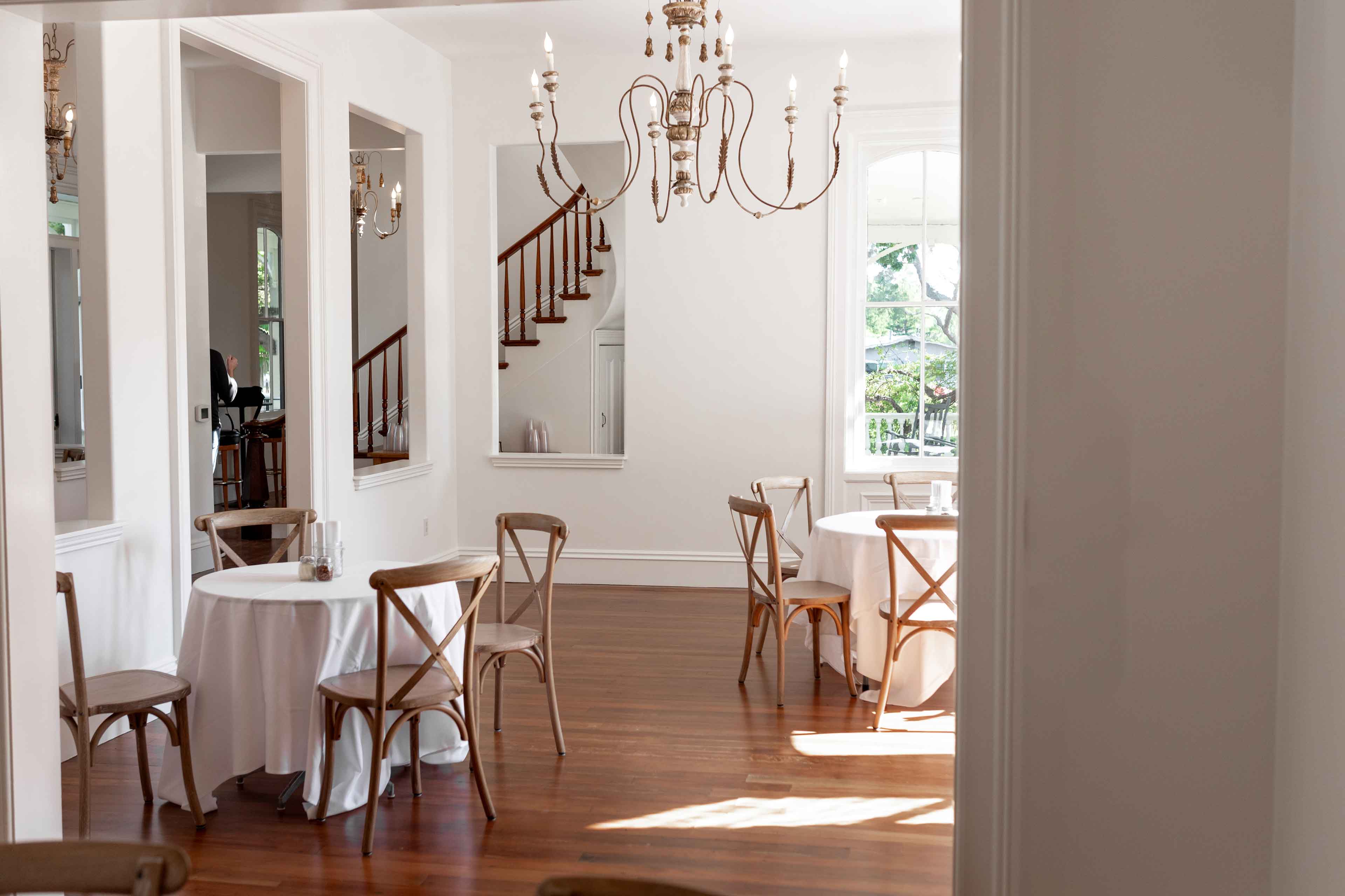 Well lit dining floor with staircase in the background