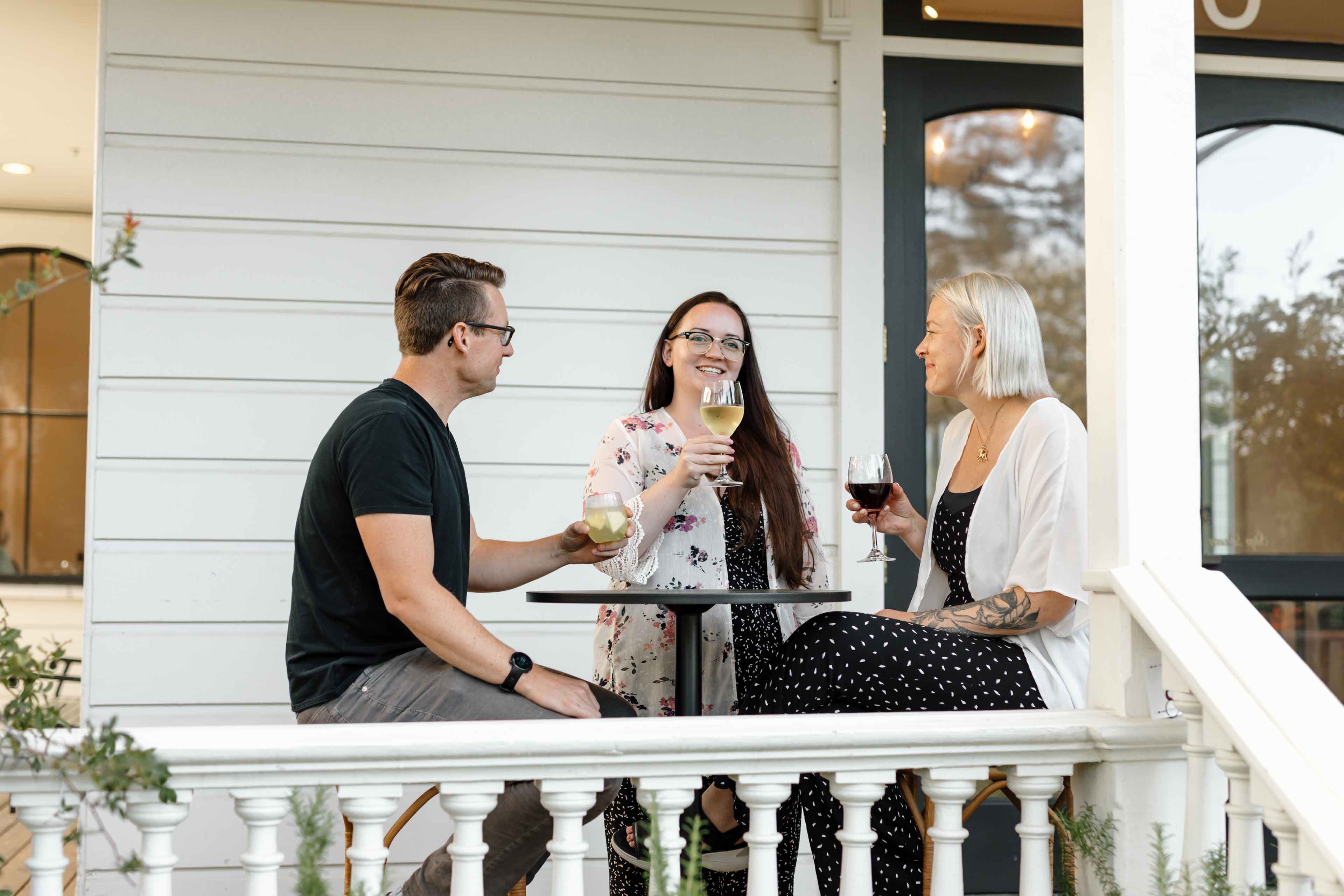 Guests enjoying wine on front porch
