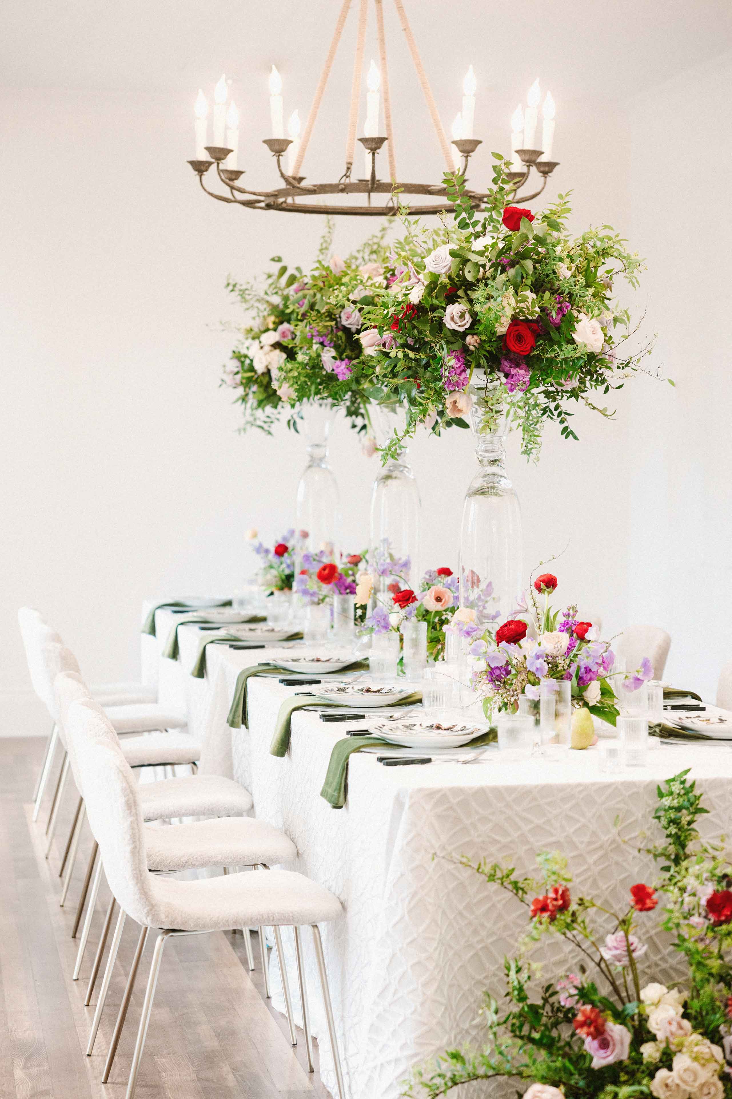 Indoor table set and decorated in bright floral arrangements