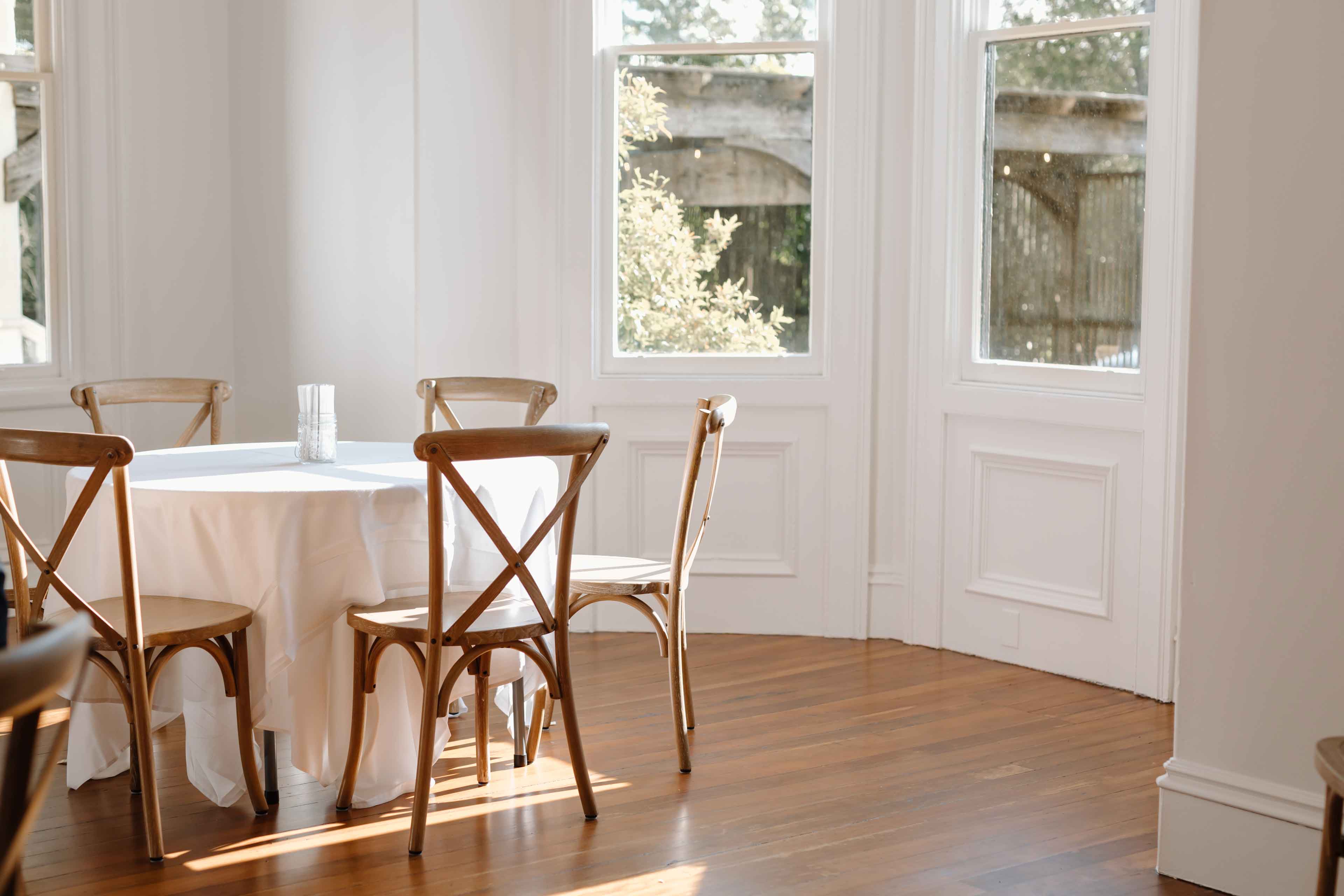 White table with wooden chairs indoor seating