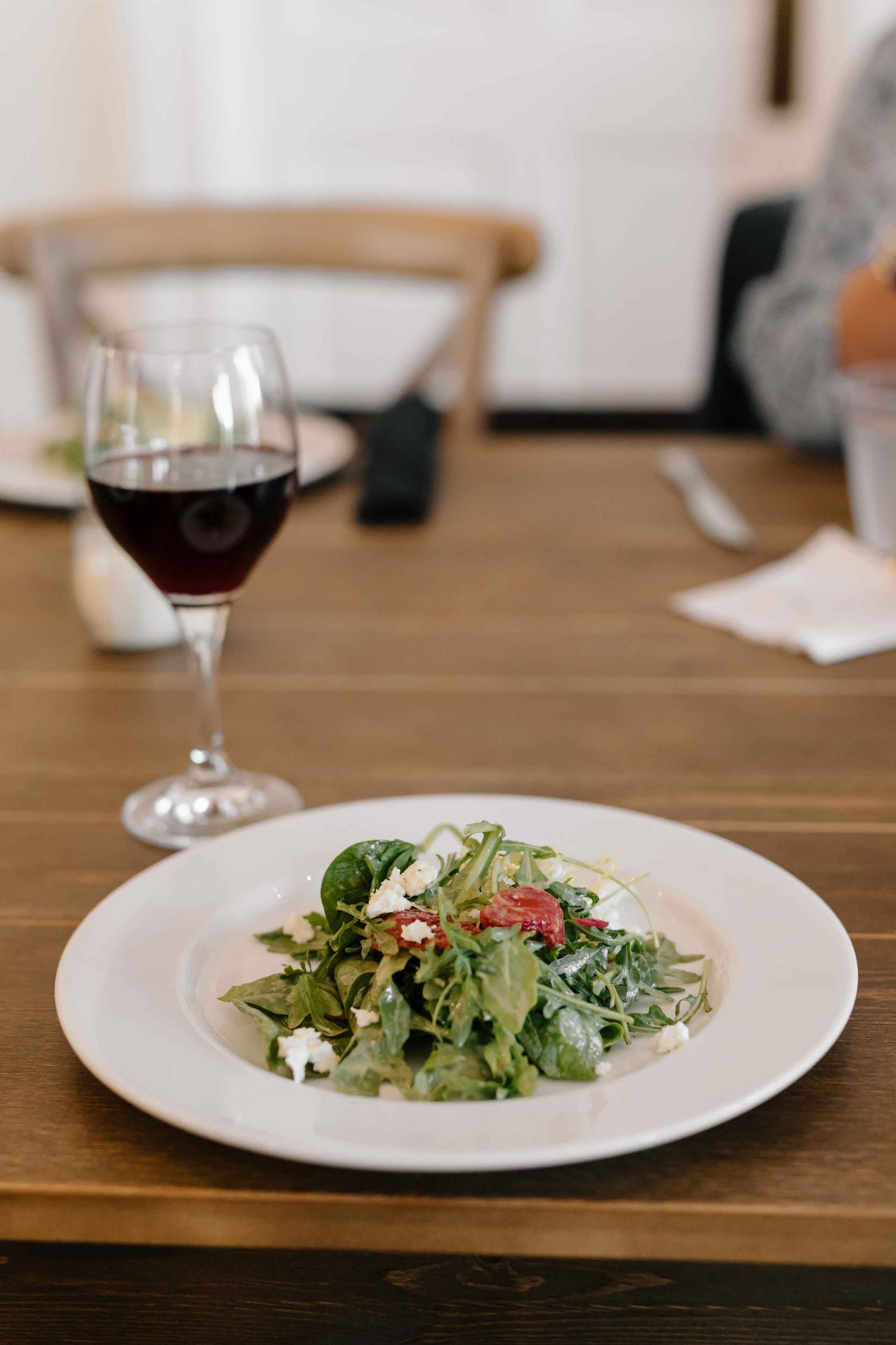 wine and salad at pizza and pinot